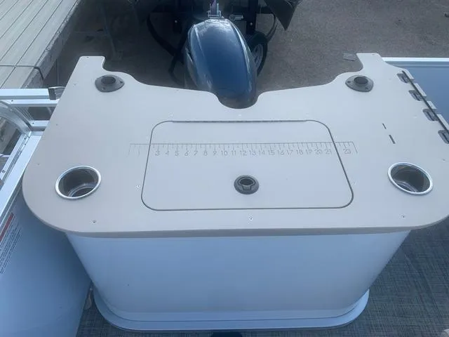 Slide: The Image of SunCatcher Select 18F 2023 boat console with cup holders and measurement guide. - 5