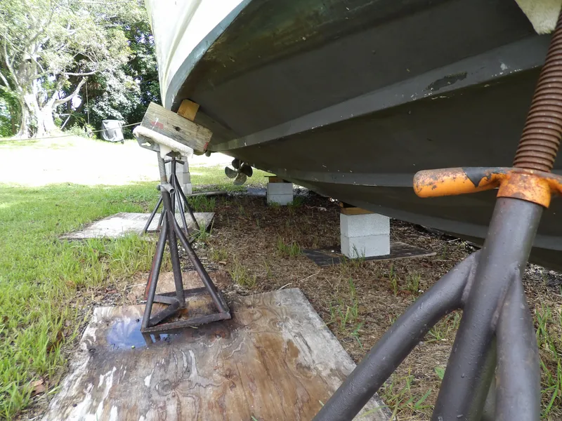 Slide: The Image of 2005 Sea Ray 360 Sundancer on stands, under maintenance, grassy area. - 13