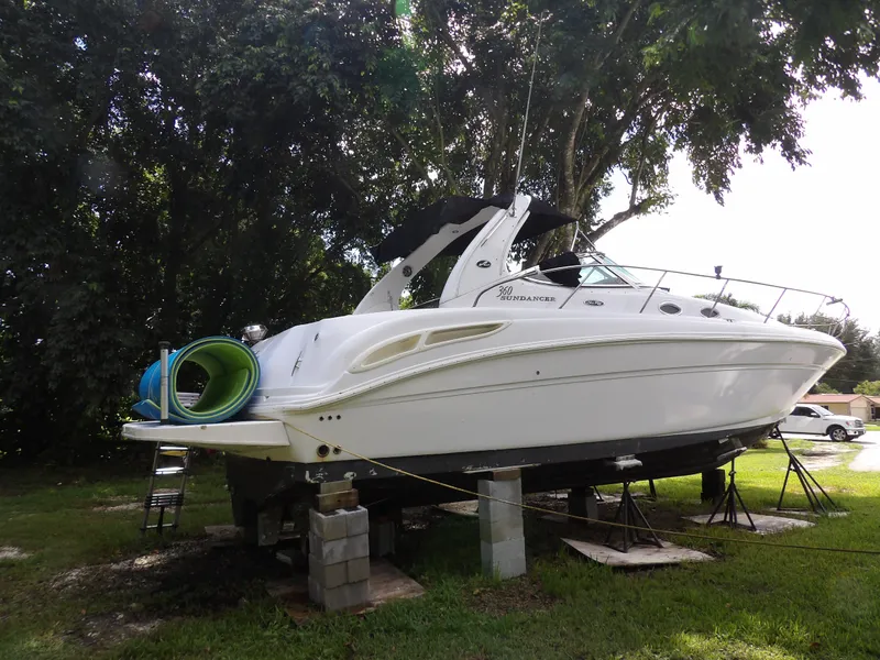 Slide: The Image of 2005 Sea Ray 360 Sundancer yacht on blocks, surrounded by trees. - 14