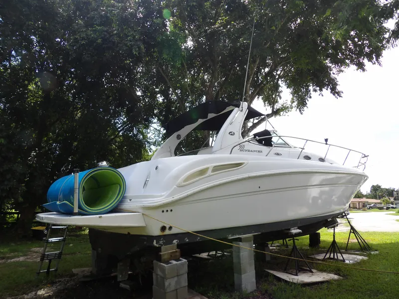 Slide: The Image of 2005 Sea Ray 360 Sundancer yacht on blocks, surrounded by trees. - 15