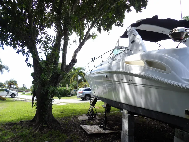 Slide: The Image of 2005 Sea Ray 360 Sundancer yacht on stands under trees. - 18