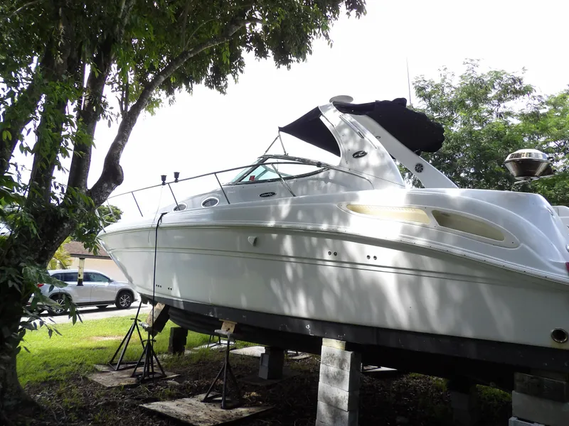 Slide: The Image of 2005 Sea Ray 360 Sundancer yacht on stands, surrounded by trees. - 19