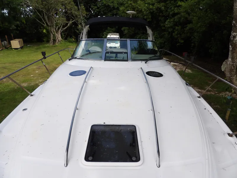 Slide: The Image of 2005 Sea Ray 360 Sundancer boat on grassy area, front deck view. - 20