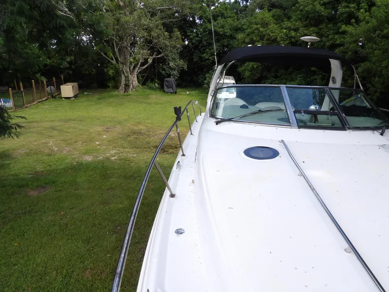 Slide: The Image of 2005 Sea Ray 360 Sundancer boat on grassy area with trees in background. - 22