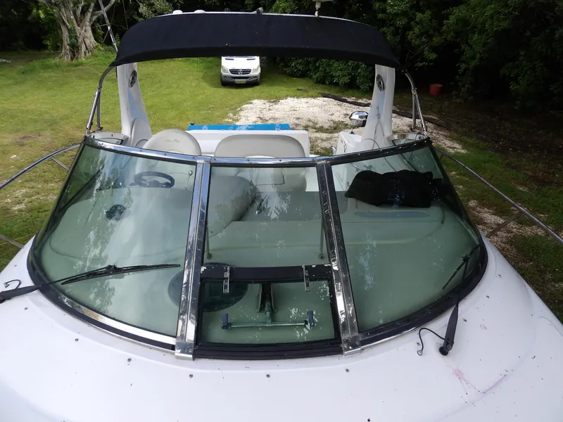 Slide: The Image of 2005 Sea Ray 360 Sundancer boat with sleek windshield and black canopy. - 23