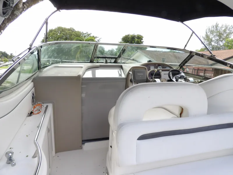 Slide: The Image of 2005 Sea Ray 360 Sundancer cockpit with white seating and modern controls. - 26