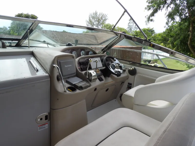 Slide: The Image of 2005 Sea Ray 360 Sundancer helm with steering wheel and navigation controls. - 27