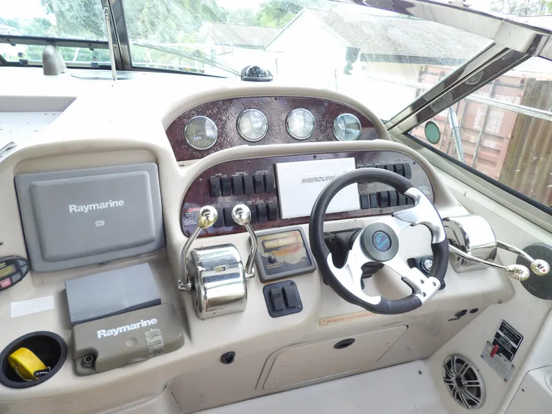 Slide: The Image of Cockpit of 2005 Sea Ray 360 Sundancer with Raymarine navigation system and steering wheel. - 28