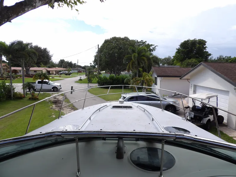 Slide: The Image of 2005 Sea Ray 360 Sundancer yacht parked in a residential driveway. - 30