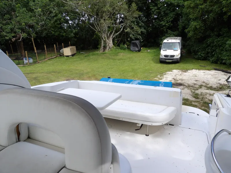 Slide: The Image of 2005 Sea Ray 360 Sundancer boat interior with seating, parked on grassy area. - 33