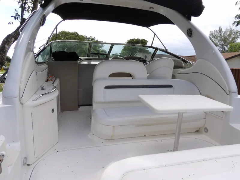 Slide: The Image of 2005 Sea Ray 360 Sundancer interior with seating and table, featuring sleek white design. - 35