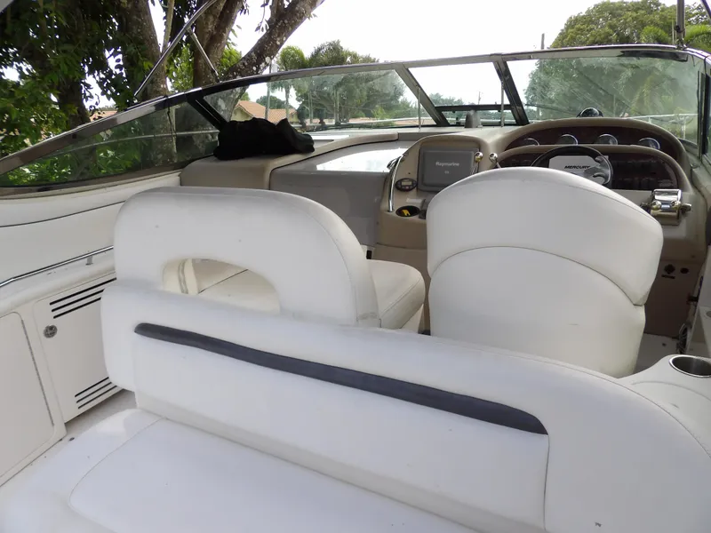 Slide: The Image of 2005 Sea Ray 360 Sundancer cockpit with white seating and dashboard view. - 38