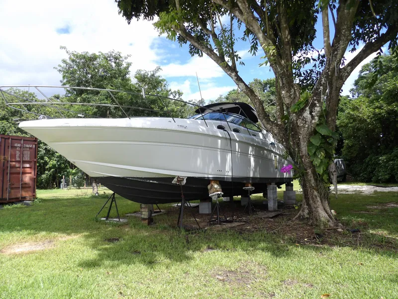 Slide: The Image of 2005 Sea Ray 360 Sundancer yacht on land, surrounded by trees. - 4