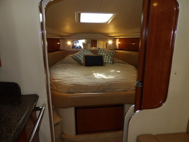 Slide: The Image of 2005 Sea Ray 360 Sundancer cabin with cozy bed and pillows. - 46