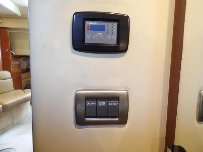 Slide: The Image of Control panel and switches inside 2005 Sea Ray 360 Sundancer yacht cabin. - 49