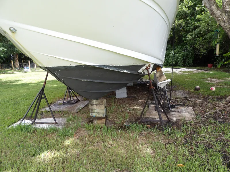 Slide: The Image of 2005 Sea Ray 360 Sundancer on stands for maintenance in grassy area. - 9