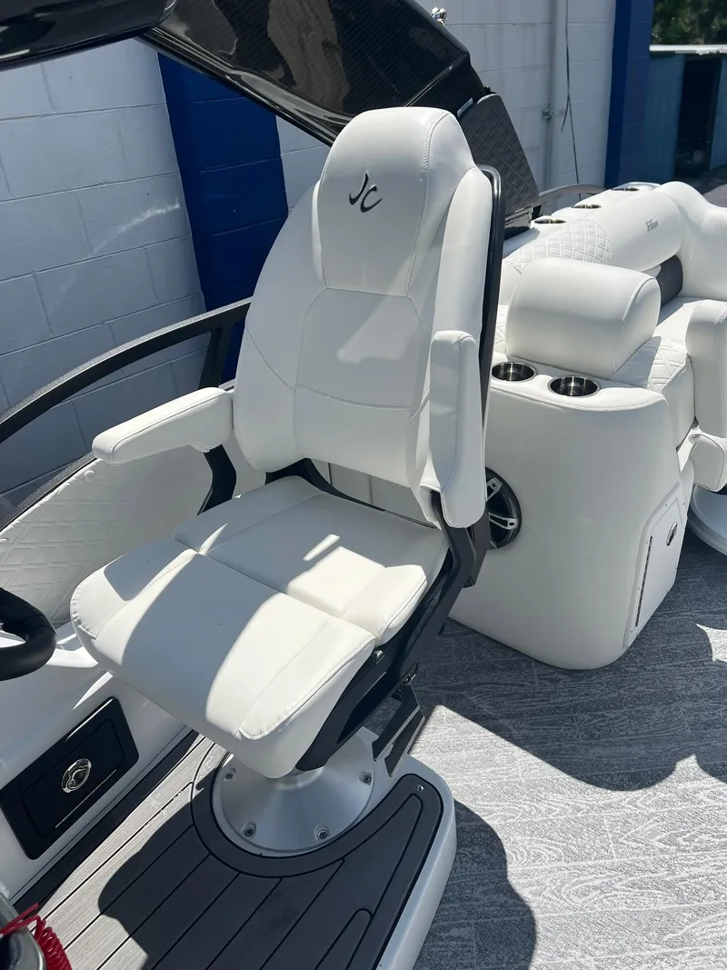 Slide: The Image of Luxury seating on 2025 JC 26 SportToon TT DSL boat, featuring sleek white design. - 11