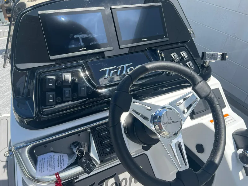 Slide: The Image of Steering console of 2025 JC 26 SportToon TT DSL with dual screens and controls. - 13