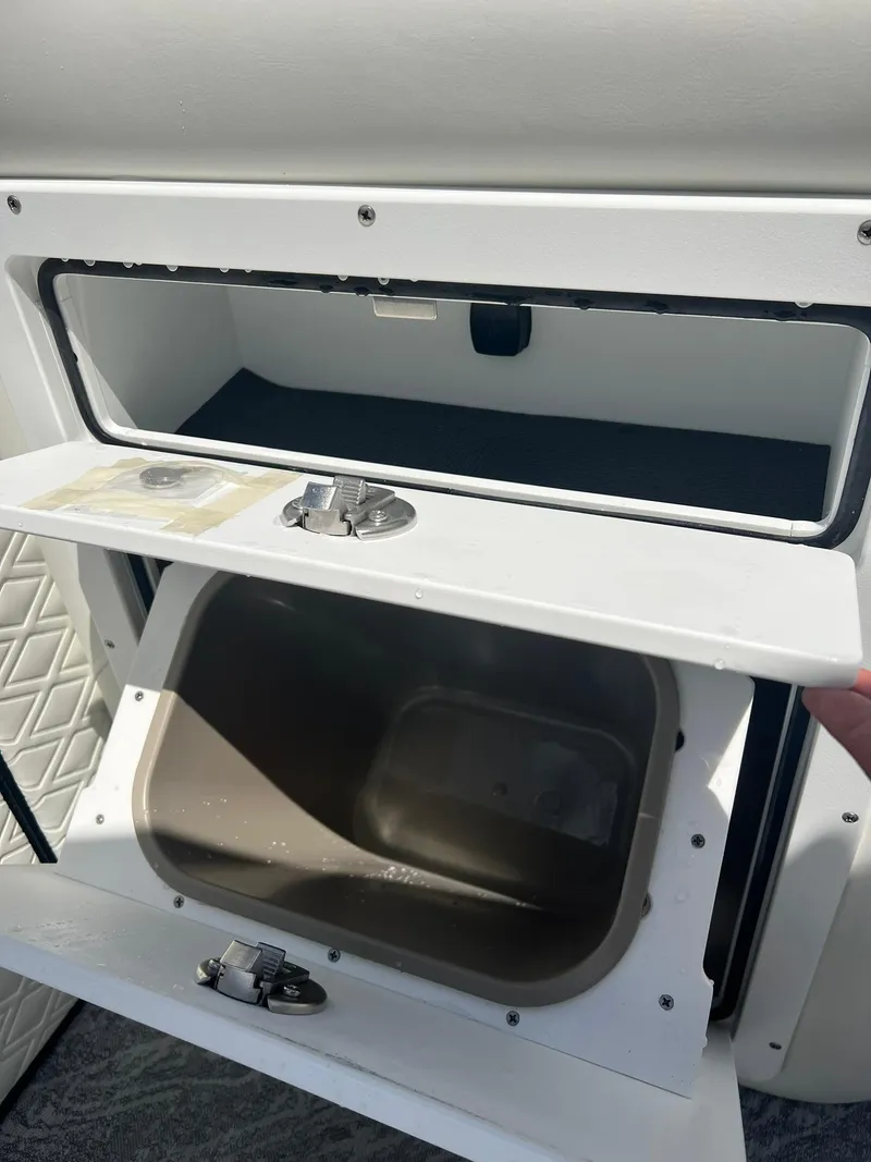 Slide: The Image of 2025 JC 26 SportToon TT DSL boat storage compartment with open hatch. - 14