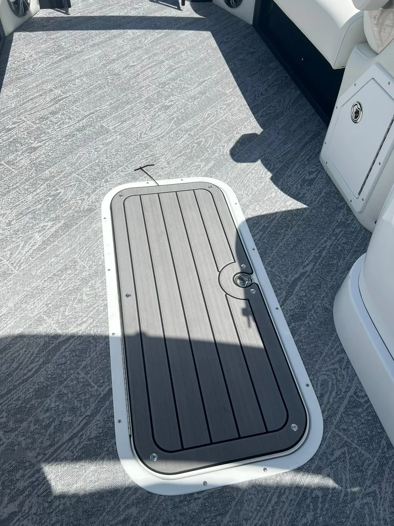 Slide: The Image of 2025 JC 26 SportToon TT DSL boat deck with storage hatch. - 15
