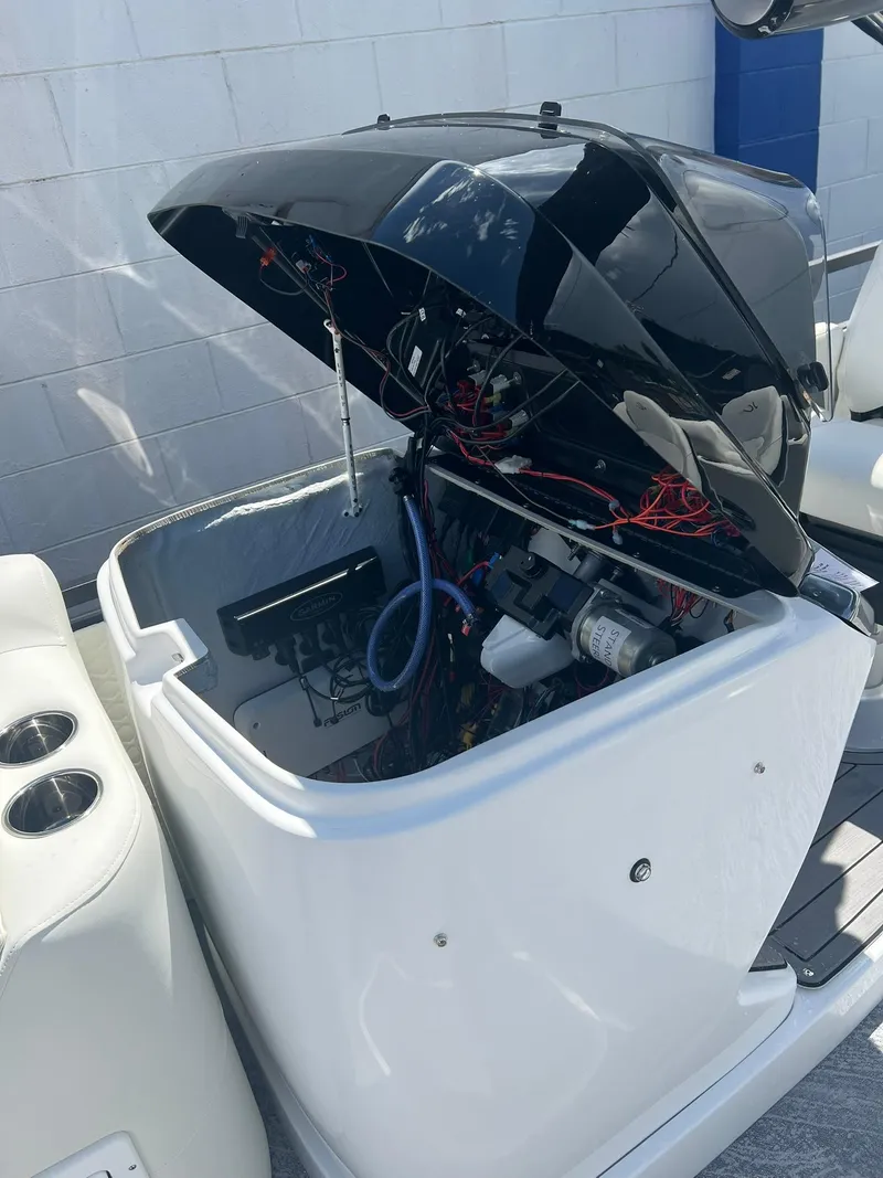 Slide: The Image of 2025 JC 26 SportToon TT DSL engine compartment with open cover, showcasing wiring and components. - 16
