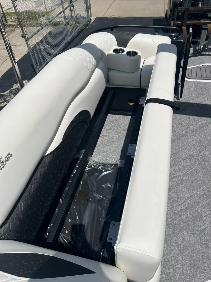 Slide: The Image of 2025 JC 26 SportToon TT DSL boat interior with white seating and cup holders. - 17