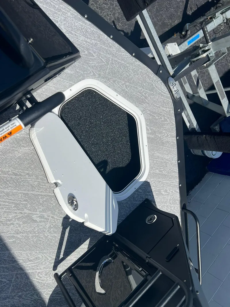 Slide: The Image of 2025 JC 26 SportToon TT DSL boat deck with open hatch and railing. - 18