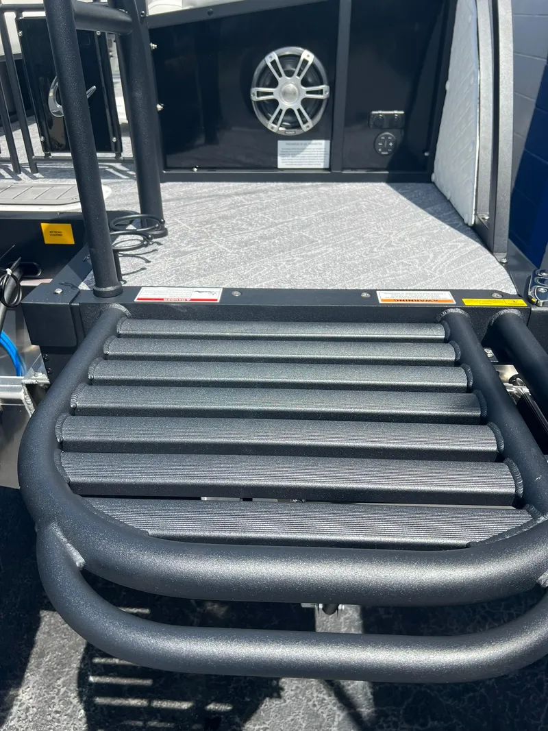 Slide: The Image of 2025 JC 26 SportToon TT DSL boat deck with speaker and railing. - 29