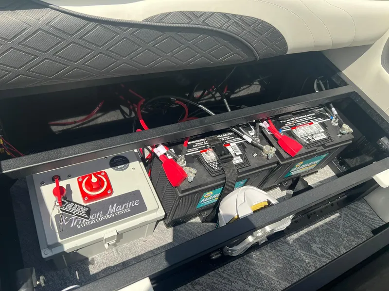 Slide: The Image of Battery compartment of 2025 JC 26 SportToon TT DSL boat with wiring and control panel. - 9
