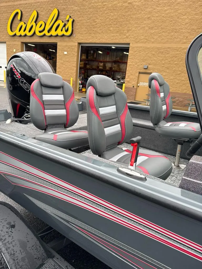 Slide: The Image of 2024 Ranger VS1782SC Angler boat with stylish seating, displayed outside Cabela's store. - 2