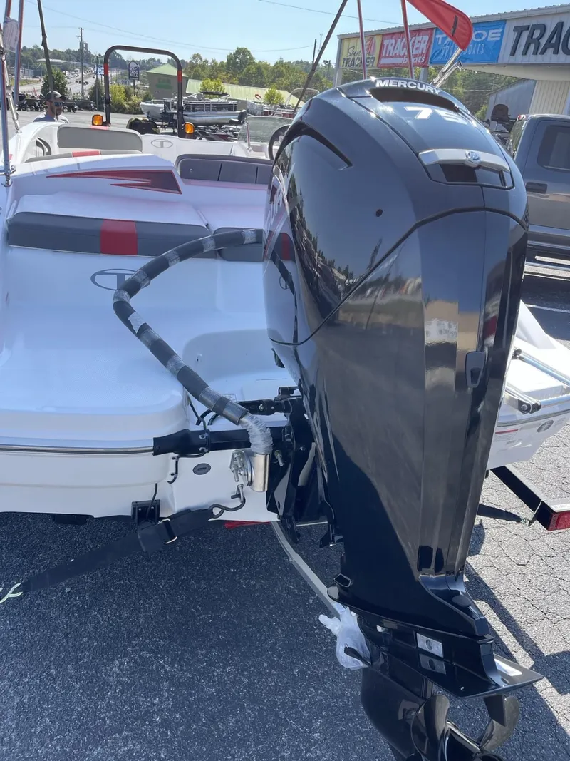 Slide: The Image of 2024 Tahoe T16 boat with Mercury outboard motor, parked outdoors. - 1
