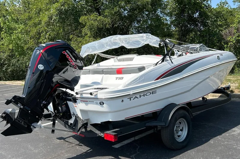 Slide: The Image of 2024 Tahoe T18 boat on trailer with outboard motor, parked outdoors. - 3