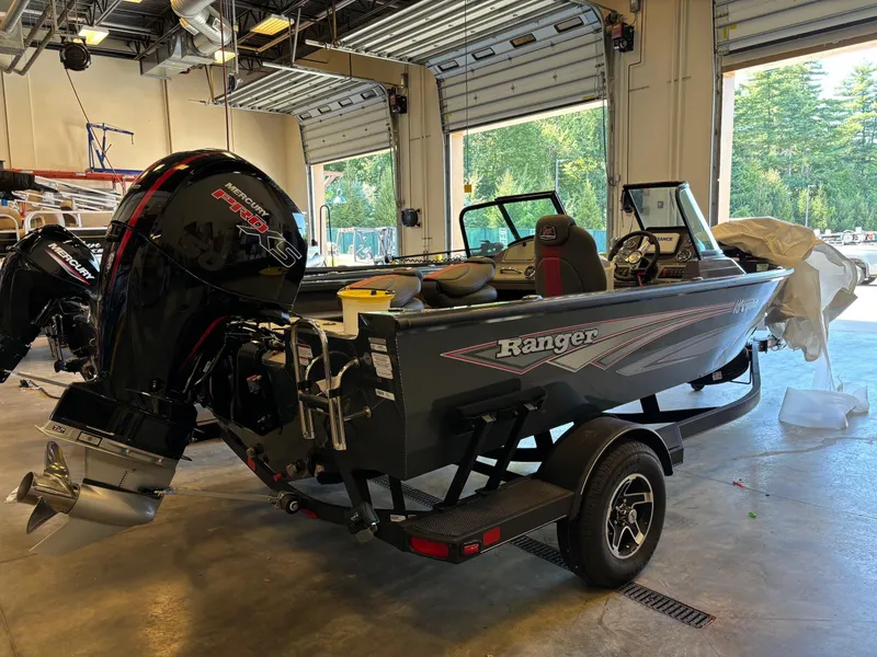 Slide: The Image of 2024 Ranger VS1782SC Angler boat in a garage, featuring a powerful outboard motor. - 0