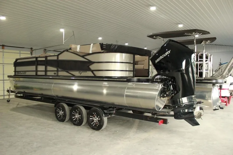 Slide: The Image of 2022 Vanderbilt 700SC pontoon boat with Mercury outboard motor in a garage. - 10
