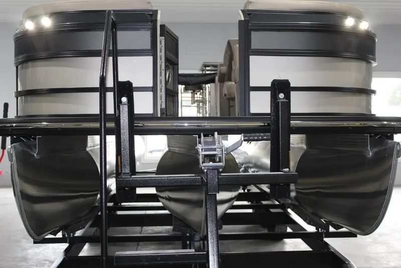 Slide: The Image of 2022 Vanderbilt 700SC pontoon boat on trailer, front view in storage facility. - 11