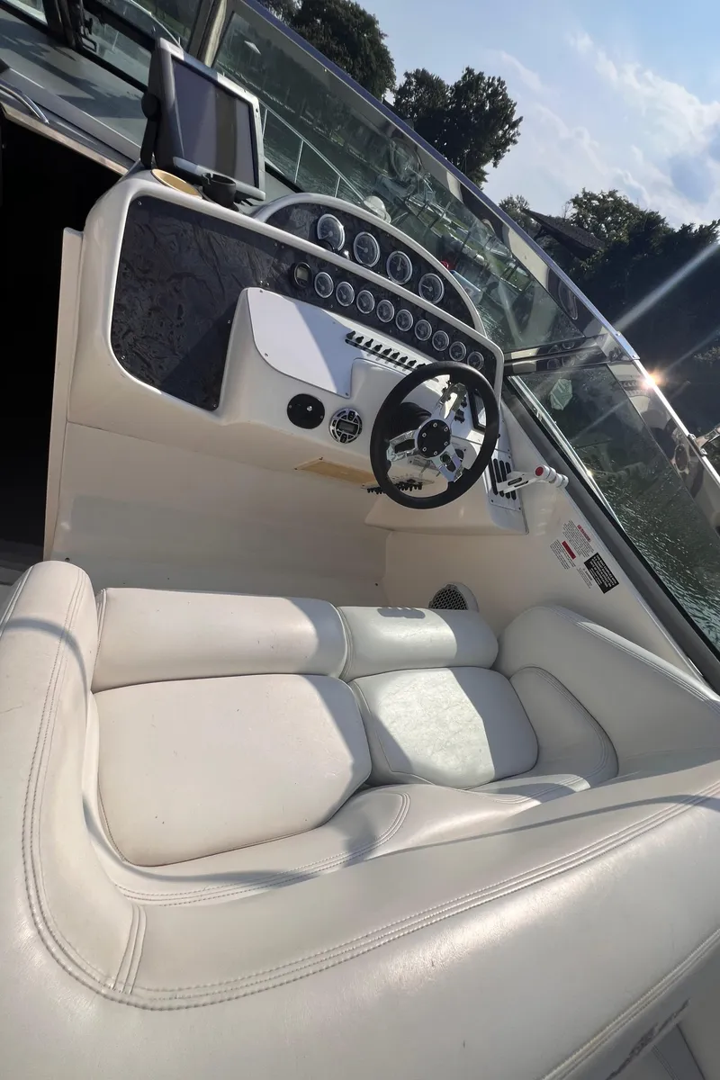 Slide: The Image of Interior of 2000 Wellcraft 45 Excalibur boat with white seating and control panel. - 10