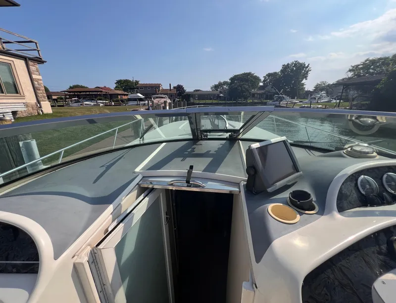 Slide: The Image of 2000 Wellcraft 45 Excalibur boat cockpit with dashboard and open cabin door. - 11
