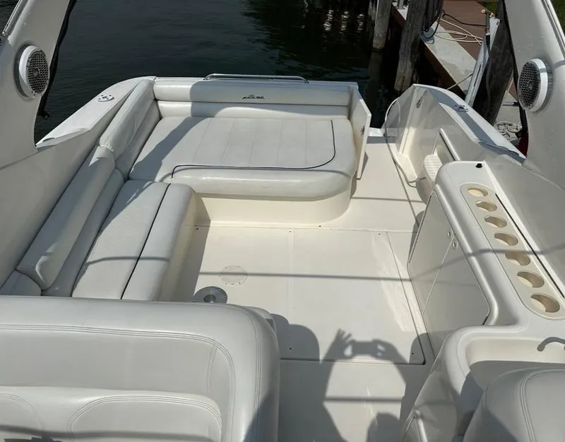 Slide: The Image of 2000 Wellcraft 45 Excalibur boat interior with white seating and cup holders. - 14