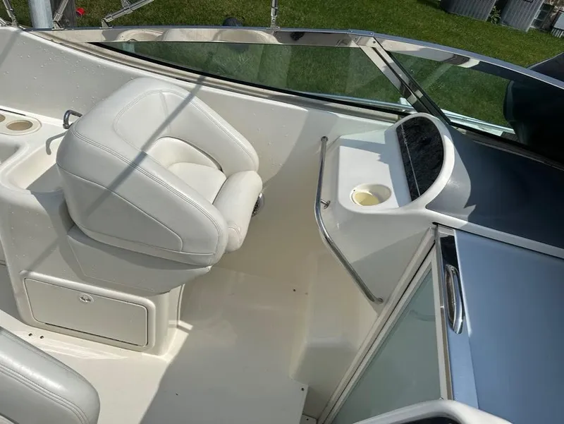 Slide: The Image of 2000 Wellcraft 45 Excalibur boat interior with white seating and dashboard. - 15