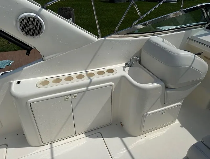 Slide: The Image of 2000 Wellcraft 45 Excalibur boat interior with white seating and storage compartments. - 16