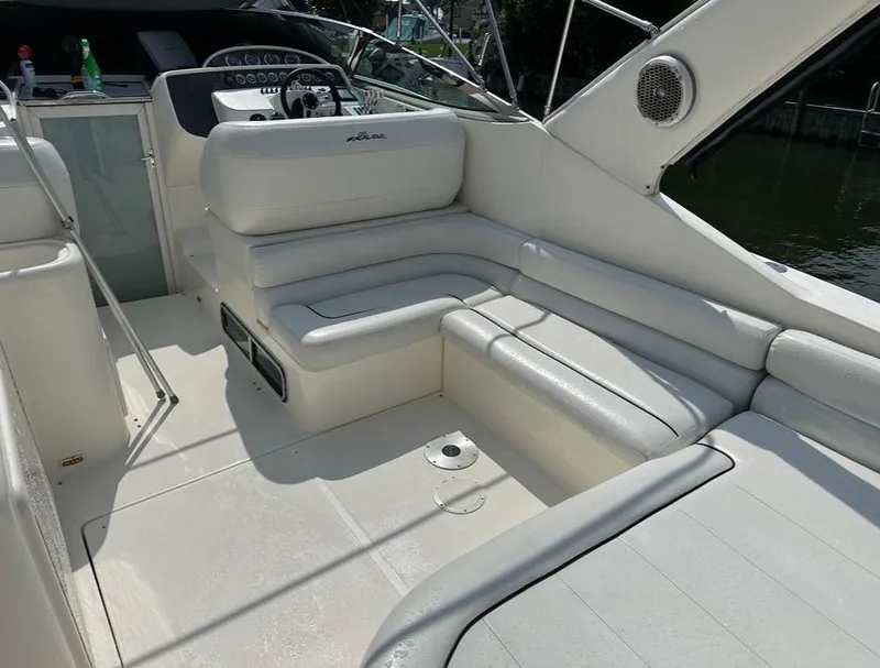 Slide: The Image of 2000 Wellcraft 45 Excalibur boat interior with white seating and steering console. - 17