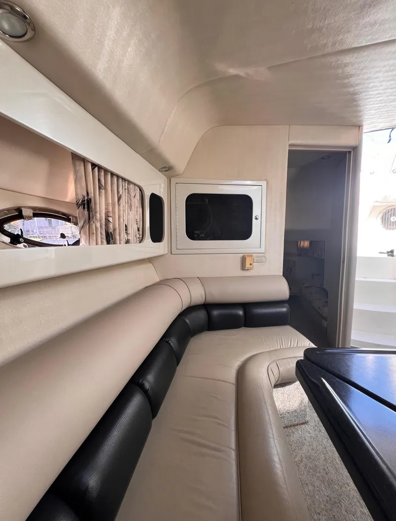 Slide: The Image of Interior of 2000 Wellcraft 45 Excalibur boat with beige and black seating. - 19