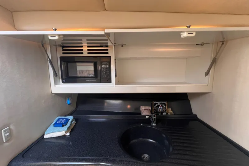 Slide: The Image of Wellcraft 45 Excalibur 2000 interior kitchen with microwave and sink. - 23