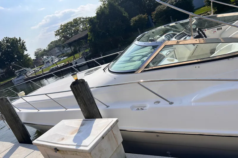 Slide: The Image of 2000 Wellcraft 45 Excalibur boat docked at a marina on a sunny day. - 3