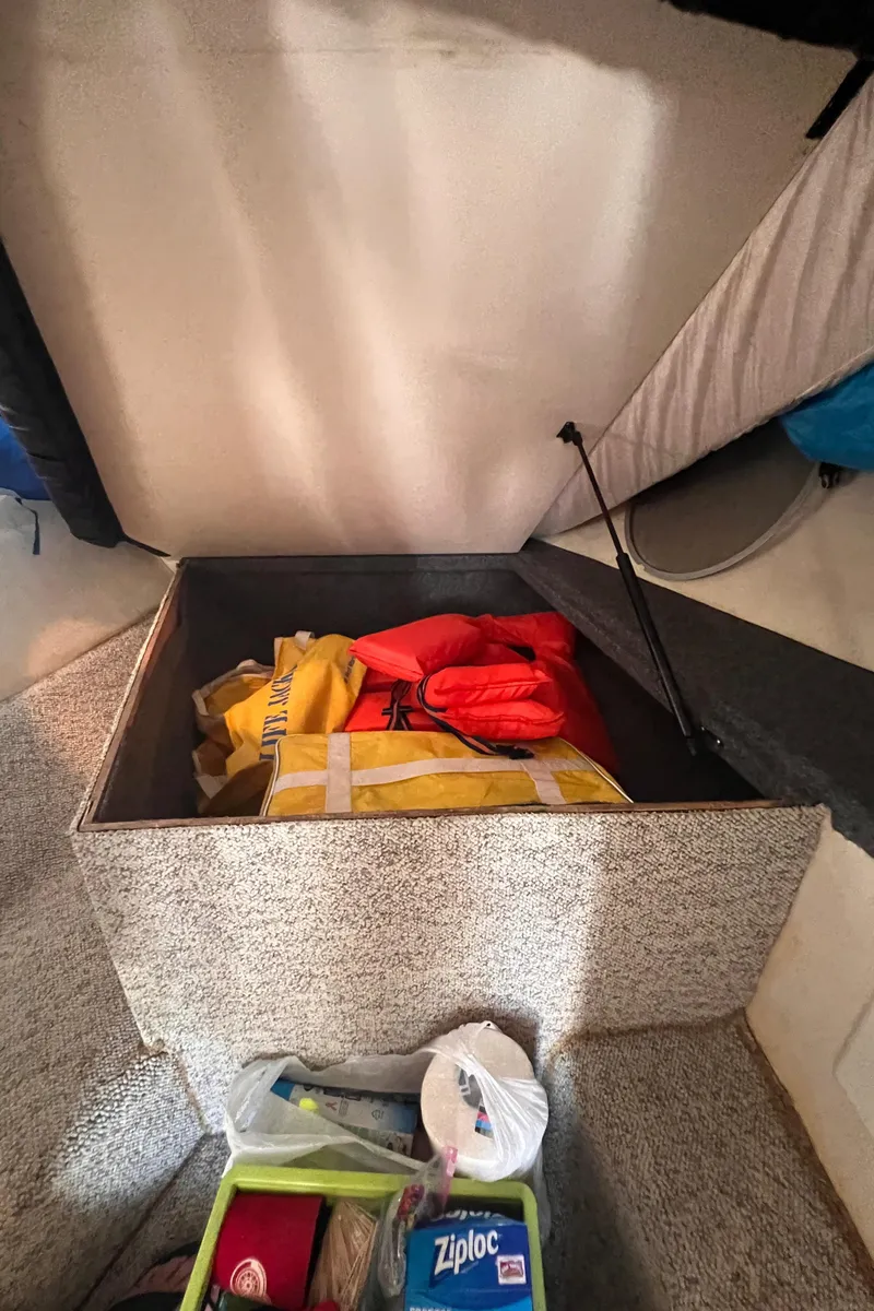 Slide: The Image of Storage compartment in a 2000 Wellcraft 45 Excalibur boat with life jackets and supplies. - 30