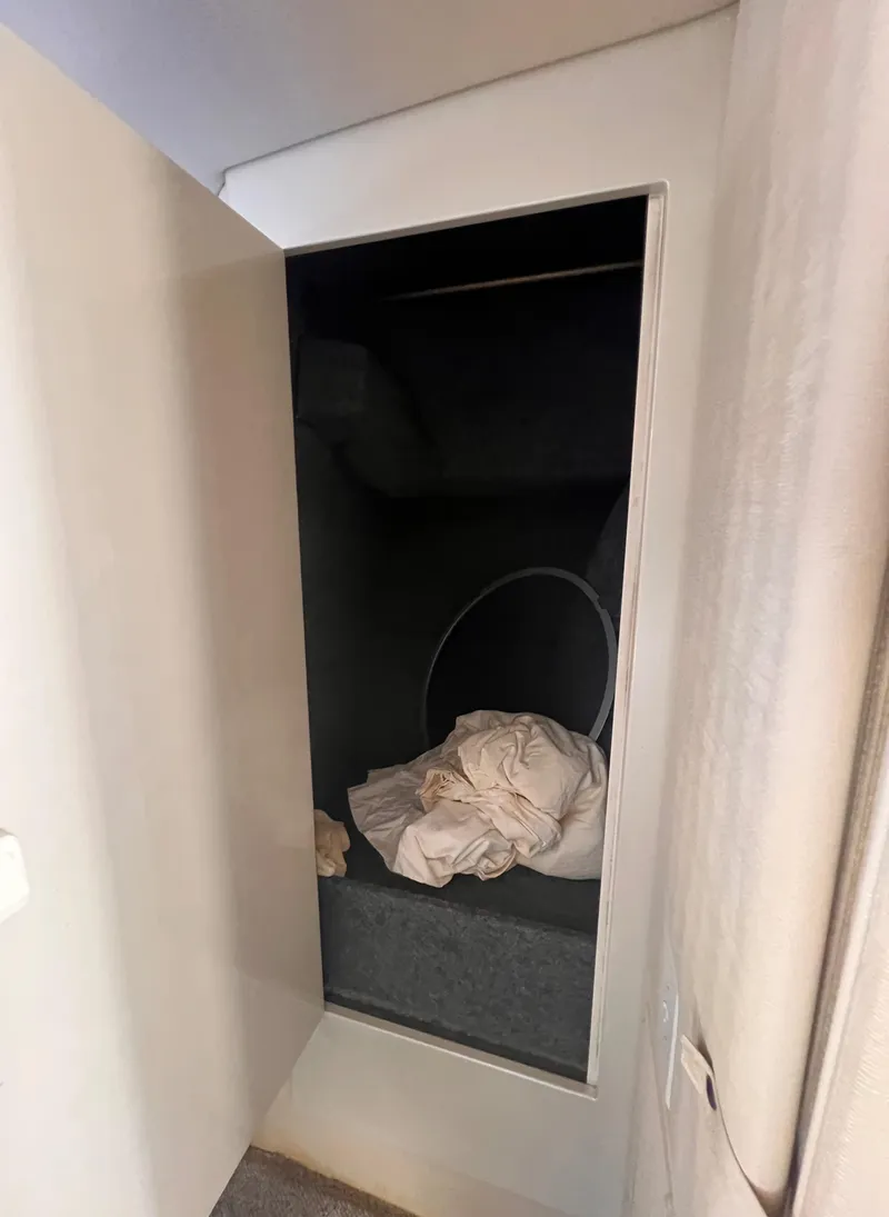 Slide: The Image of Open storage compartment in 2000 Wellcraft 45 Excalibur boat interior. - 32