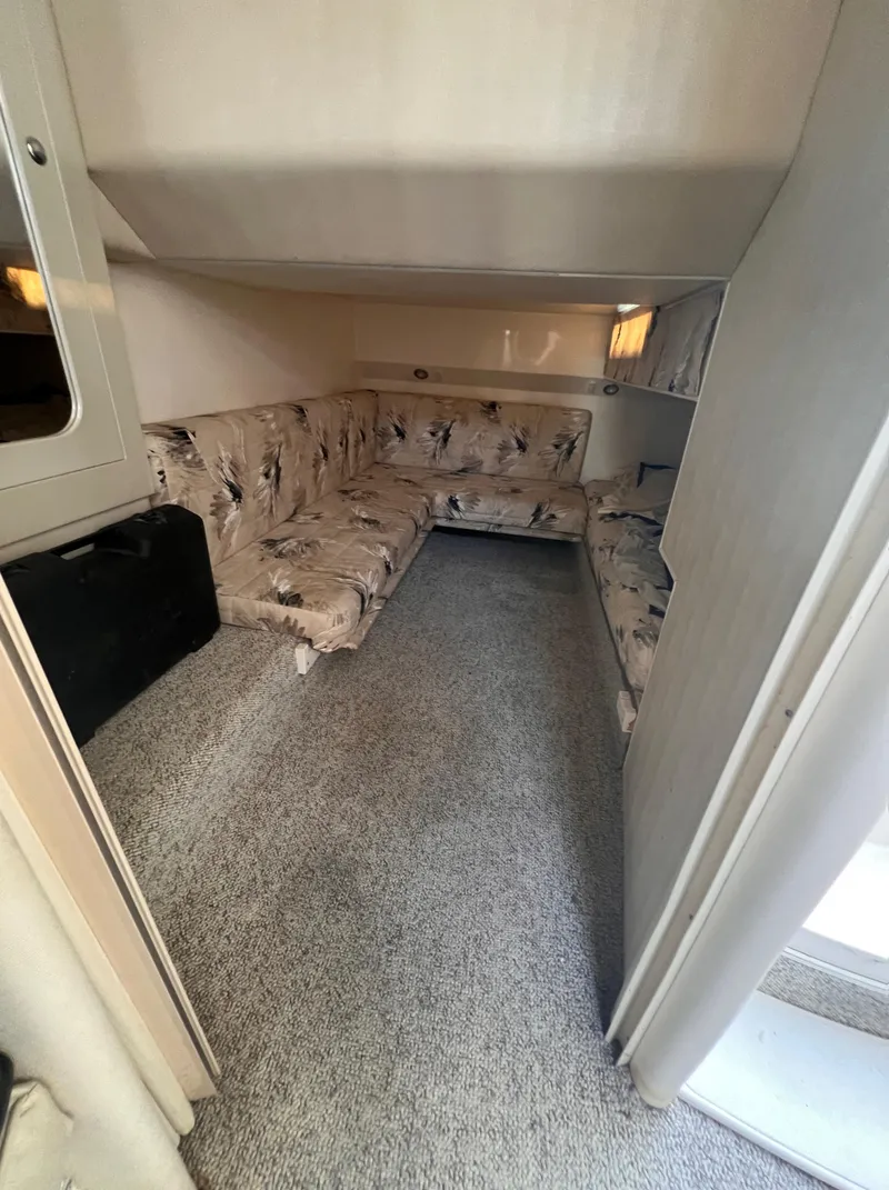 Slide: The Image of Interior of 2000 Wellcraft 45 Excalibur with floral-patterned seating and carpeted flooring. - 33