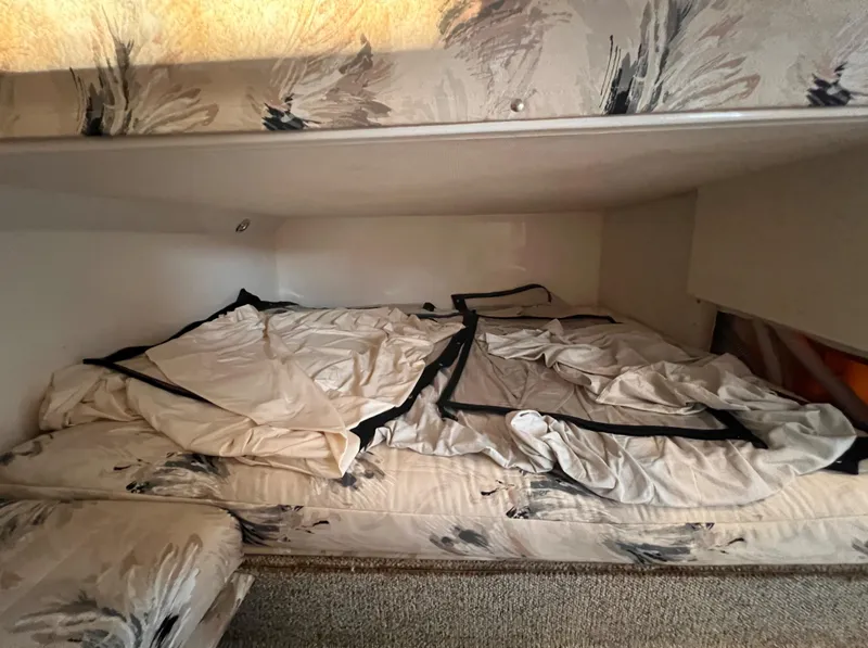 Slide: The Image of Interior cabin of 2000 Wellcraft 45 Excalibur with unmade bed and floral upholstery. - 34