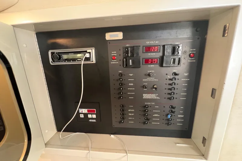 Slide: The Image of Control panel of a 2000 Wellcraft 45 Excalibur boat with audio system and switches. - 39