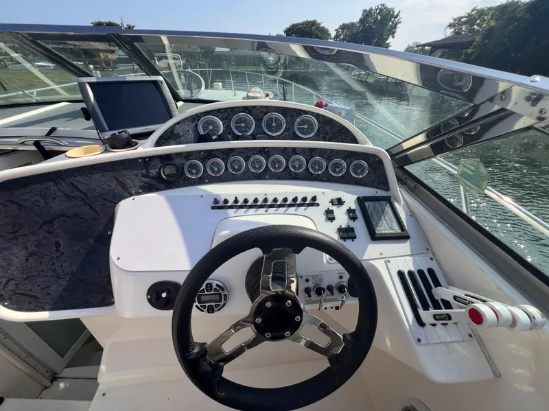Slide: The Image of Cockpit of 2000 Wellcraft 45 Excalibur boat with steering wheel and instrument panel. - 4